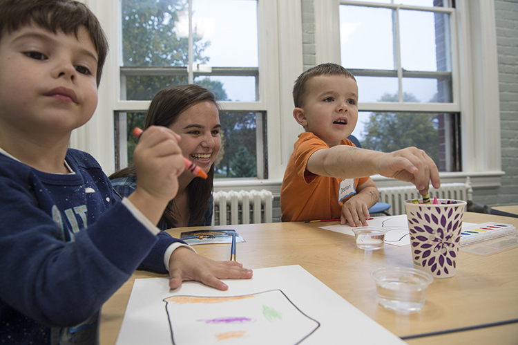 student and children at table