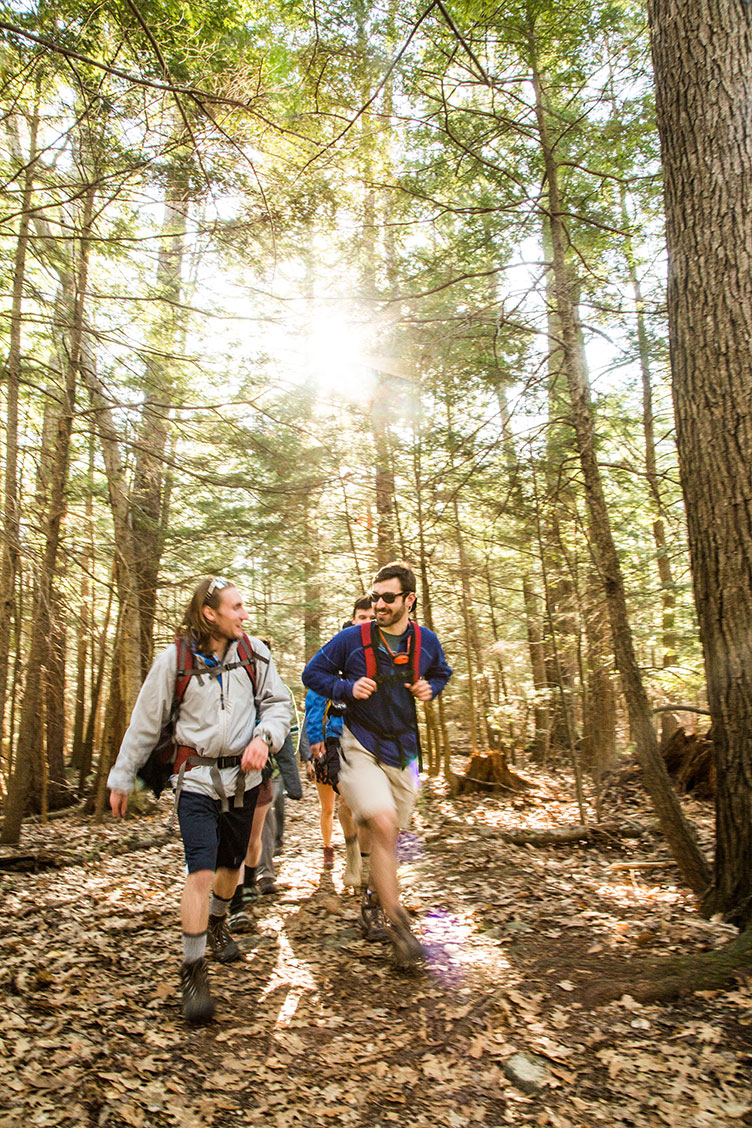 UNH students walking in College Woods