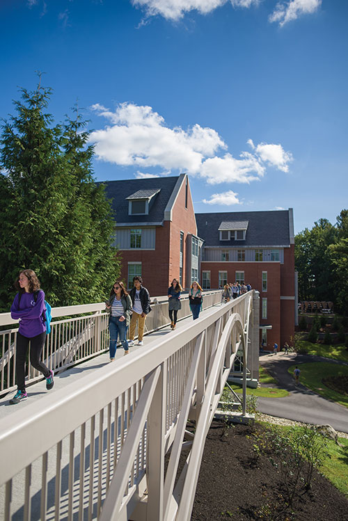 UNH students walking on the new pedestrian bridge connecting Hamilton Smith Hall with Dimond Library