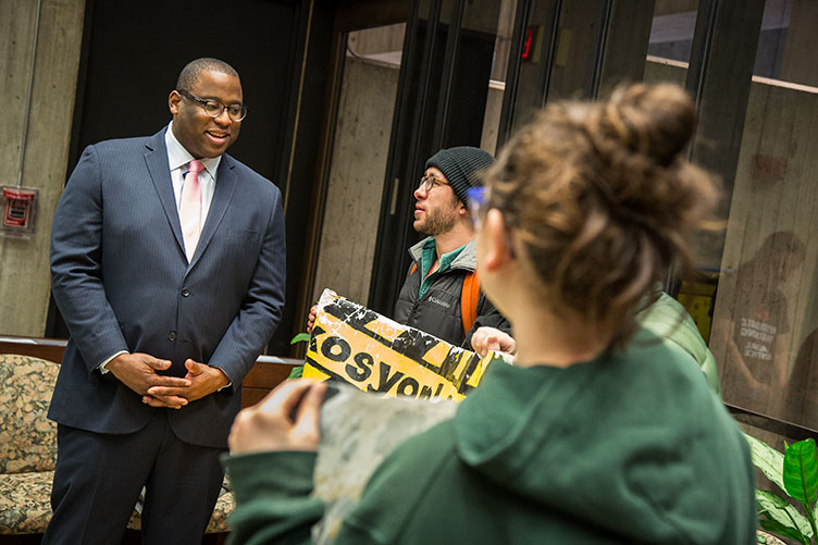 Boston city councilor and UNH alumnus Tito Jackson '99 talks with some protesters