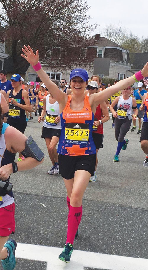 UNH alumna and runner Katie Litwinowich Meinelt ’03, ’04G crossing the finish line at the Boston Marathon