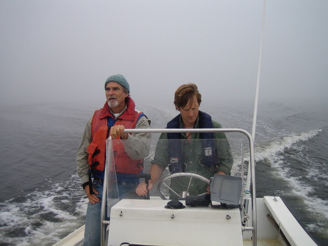 David Burdick and Gregg Moore drive boat in Great Bay fog.