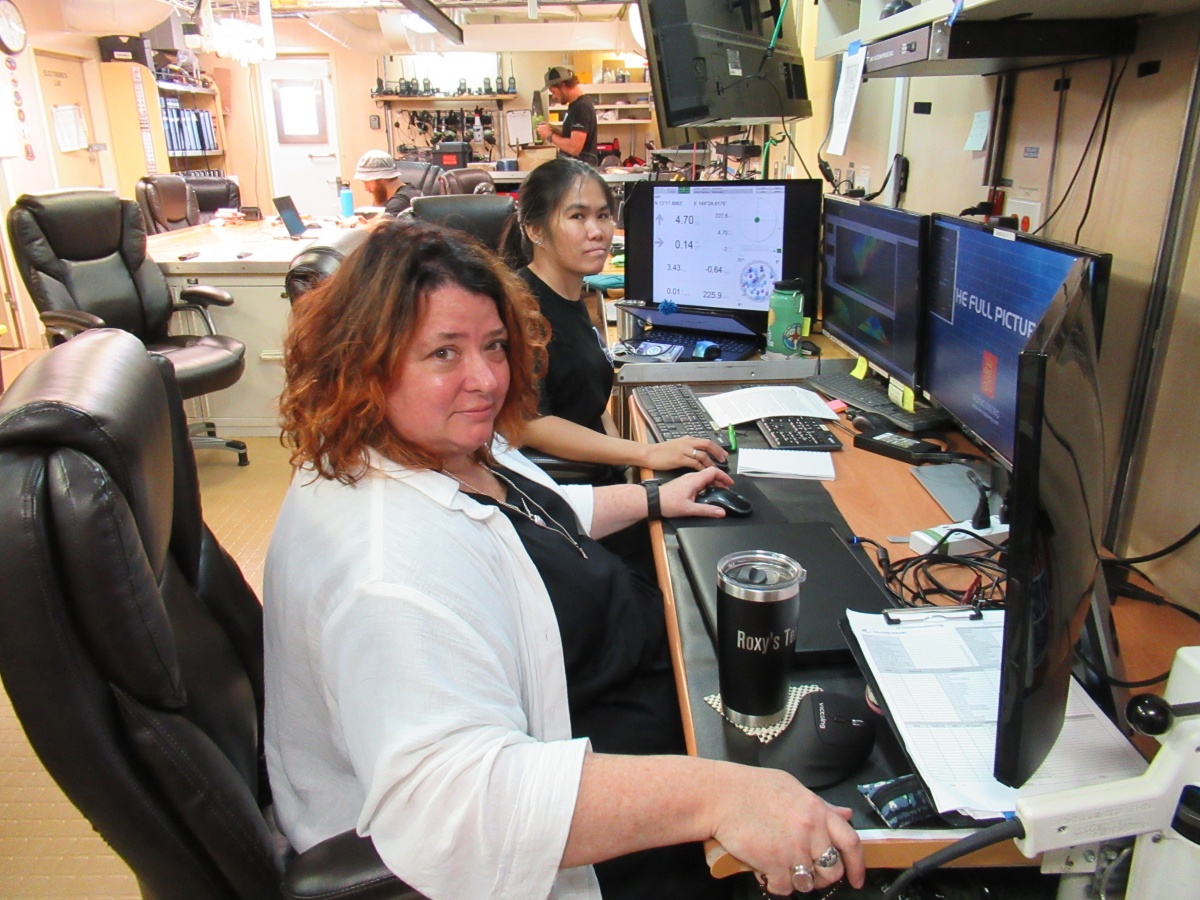 Rochelle Wigley and Jaya Roperez sit in front of computer screens in a lab aboard the DSSV Pressure Drop.