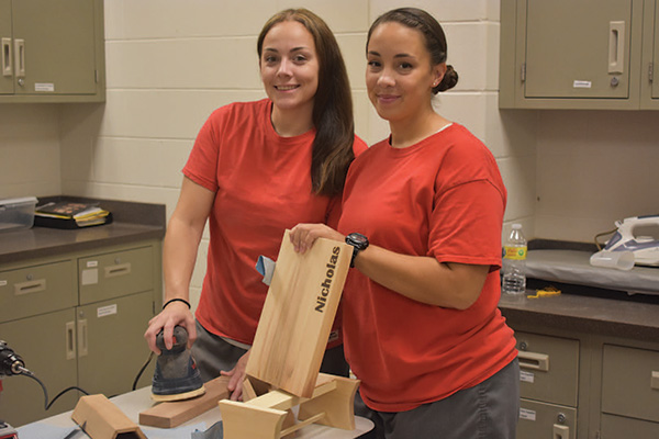 two women in classroom with wood projects