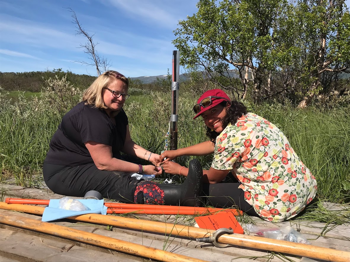 Ruth Varner and Nikki Castro Morales collect methane from lake sediments.