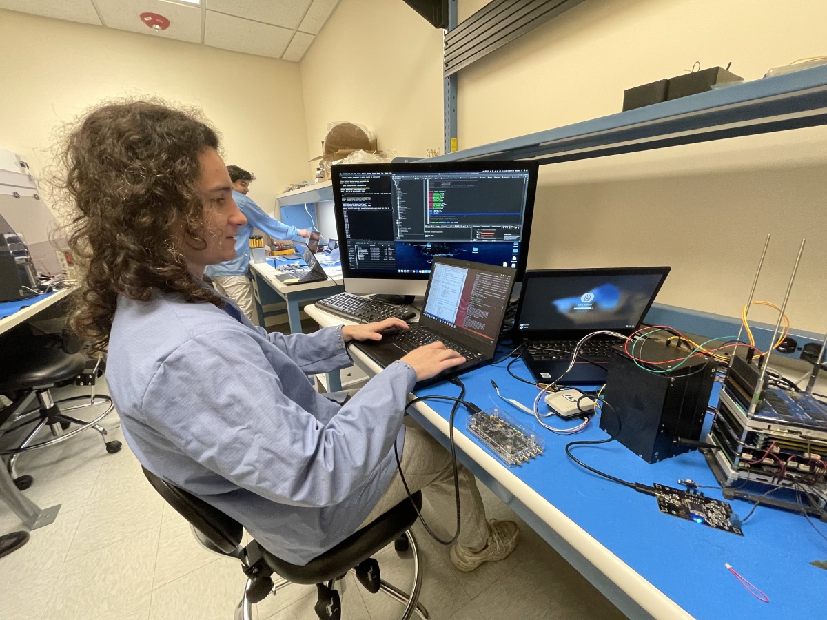 Anthony Santos works on computer code in a lab.
