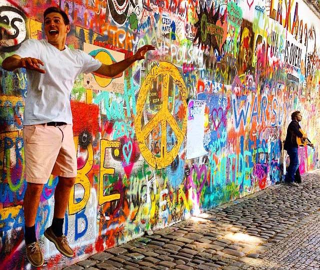 a UNH study abroad student in front of a graffiti wall
