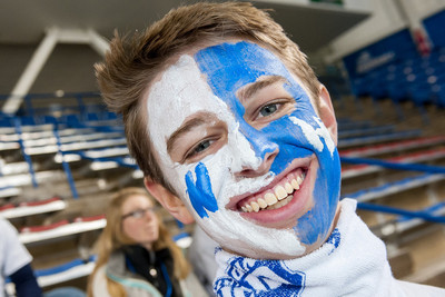 UNH student with a blue and white painted face