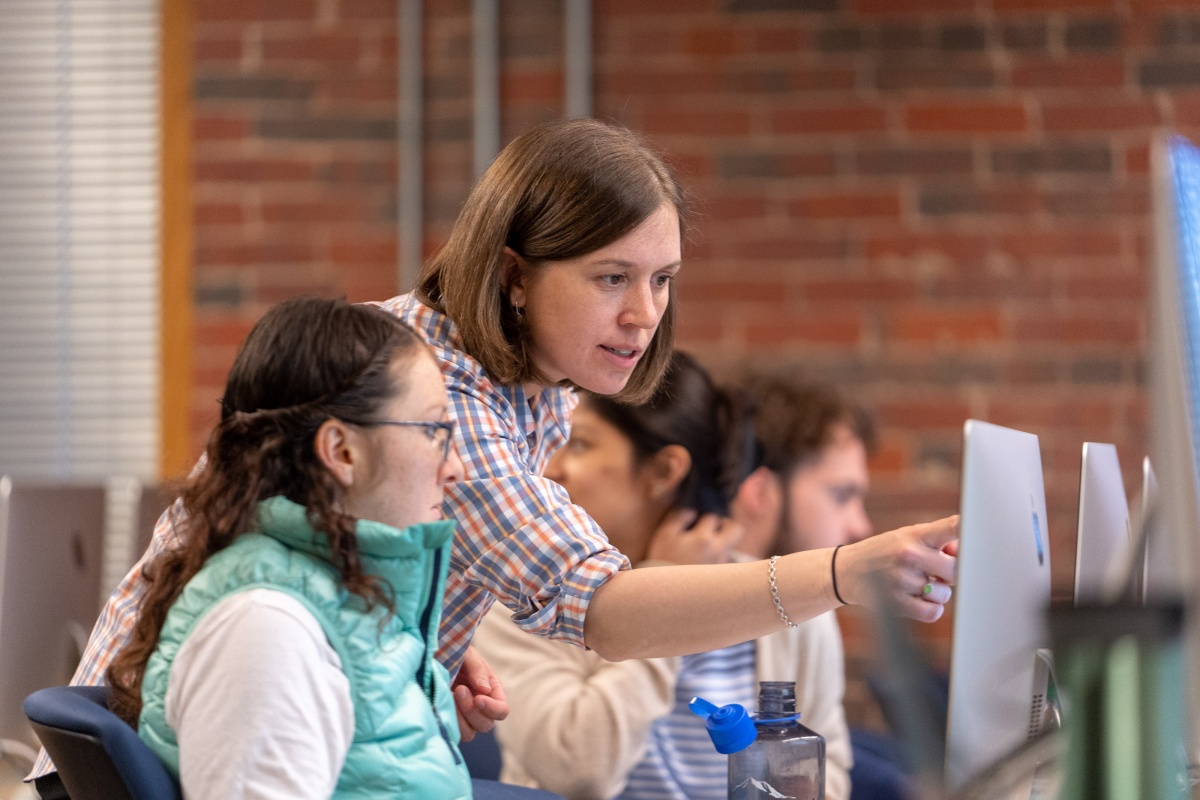 image of carolyn arcand in classroom with three students