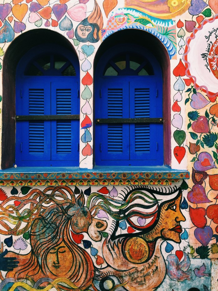 blue shutters and a wall mural in Morocco