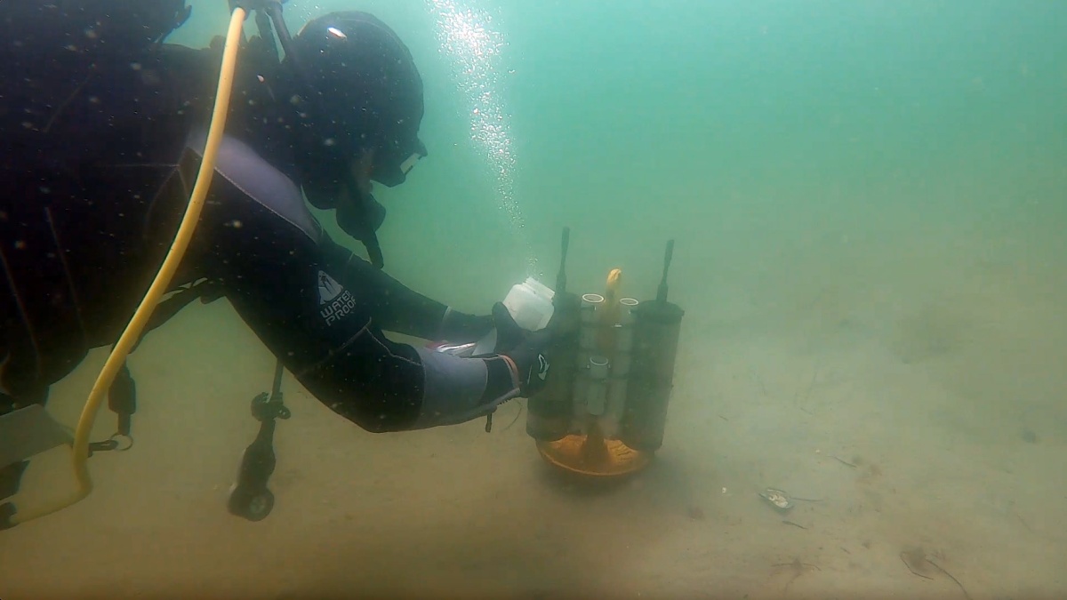 COLSA researcher Grant Milne collects water samples used for measuring DNA