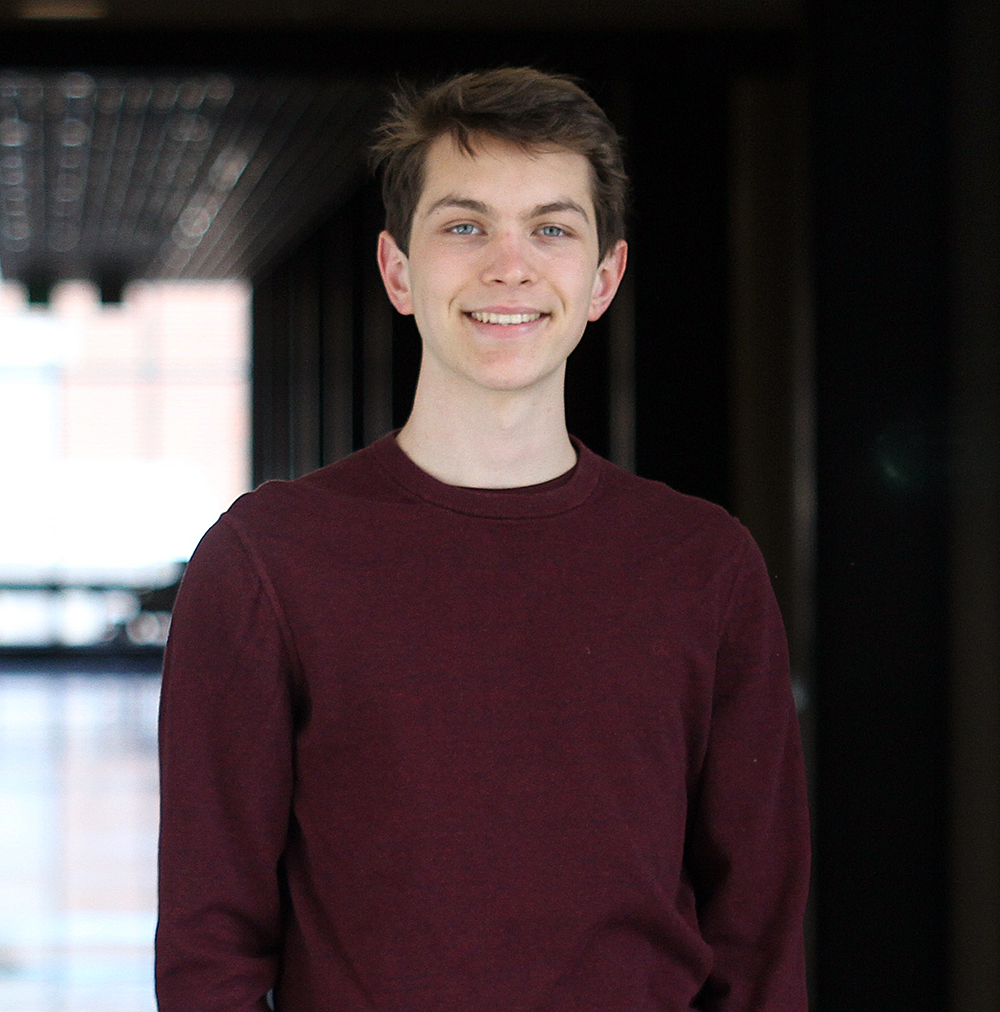 Portrait of male UNH student wearing maroon sweater