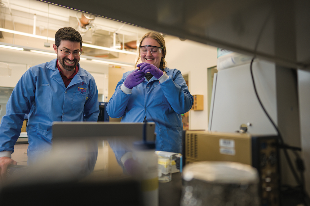 UNH researcher Jeffrey Halpern and student work in a lab