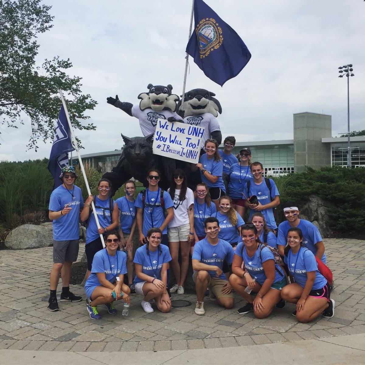 UNH students with Wild E. Cat and Gnarlz in front of the Wildcat statue