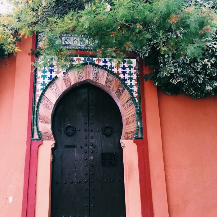 a red doorway with vines in Granada