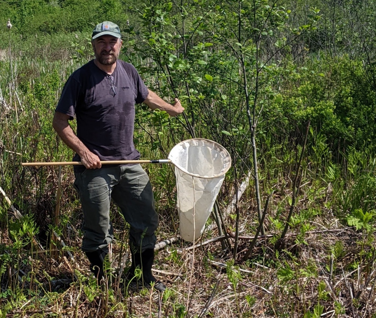 A photograph of forestry researcher Jeff Garnas doing field researcher