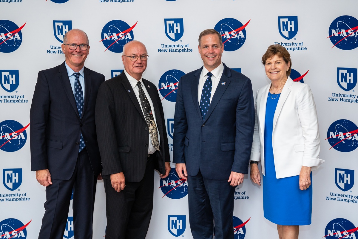 Jim Dean, Harlan Spence, Jeanne Shaheen, Jim Bridenstine in front of UNH-NASA background