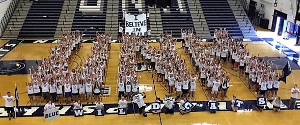 students forming the letters UNH at a pep rally