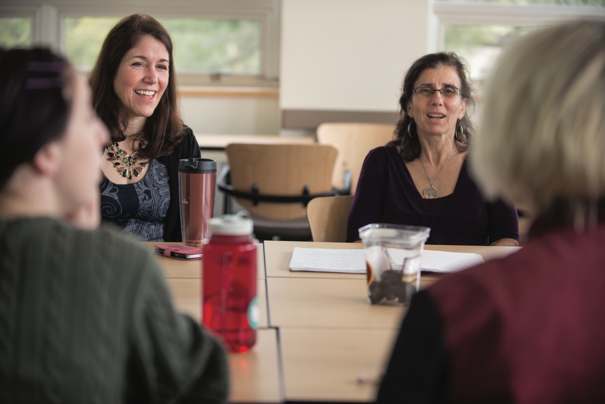 Two women sit at a conference table