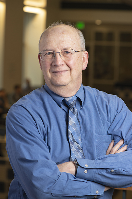 Portrait of Kenneth Johnson in a shirt and tie