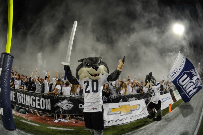 Gnarlz in front of the student section at a UNH football game