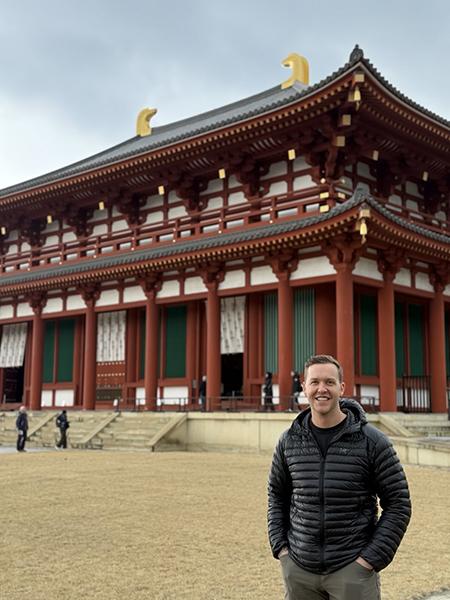 Man standing outside of an ornate building