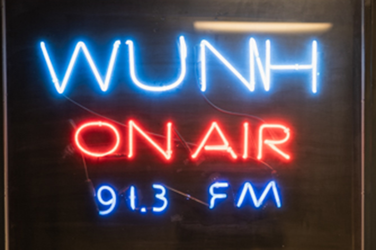 Photo of WUNH call letters in neon lights