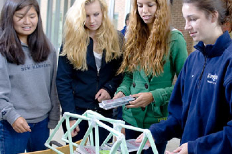 civil engineering students with paper bridge