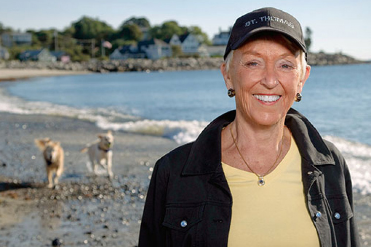 jo lamprey on the beach with her two dogs