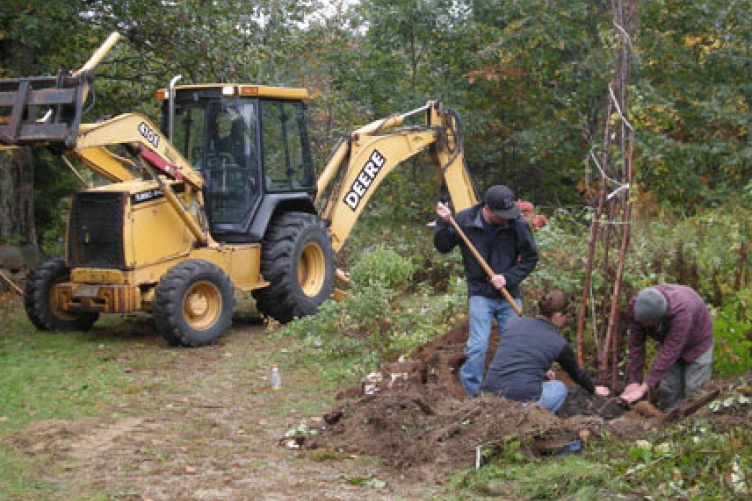 students landscaping with bulldozer assistance