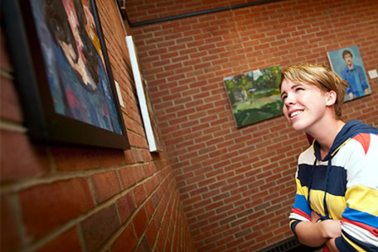 student viewing artwork in philbrook dining hall