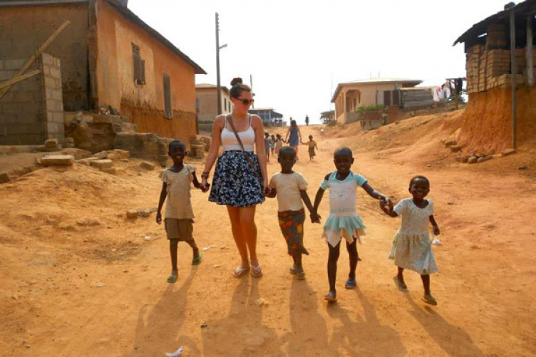 in Ghana, holding children's hands