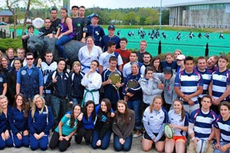 representatives from various rec sports teams, in front of Cat sculpture