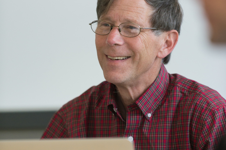 UNH professor David Finkelhor sits in front of  a laptop