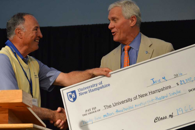 UNH President Mark Huddleston receiving a ceremonial check for the university from the class of 1966