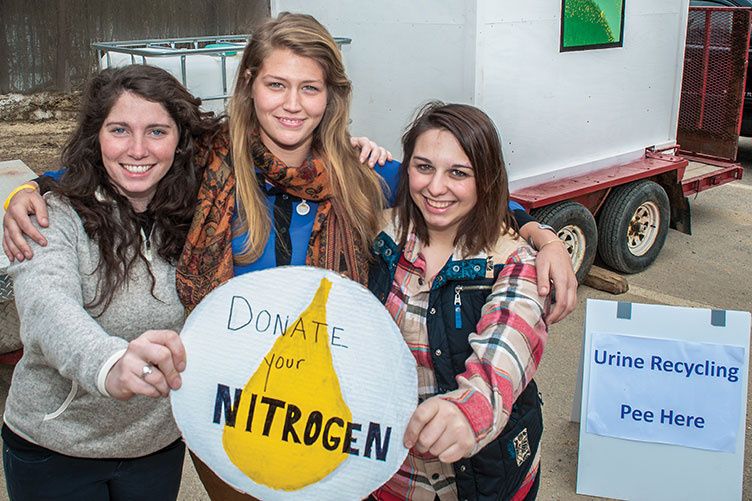 students at research project site, collecting nitrogen through urine