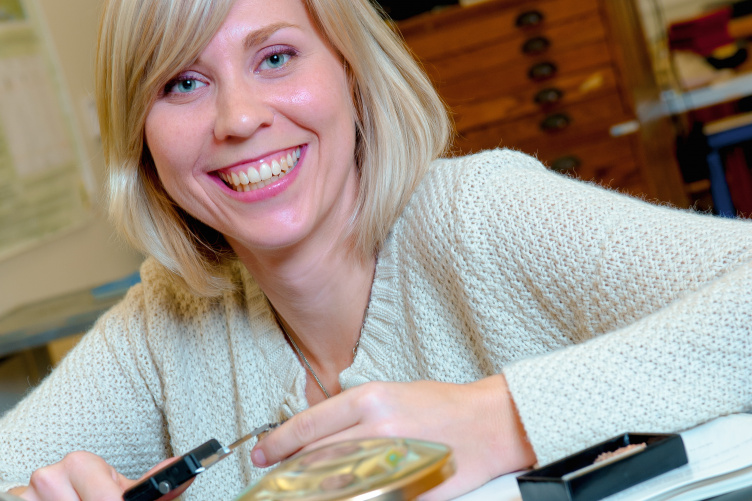 UNH graduate student Abigail D'Ambrosia holding excavation tools