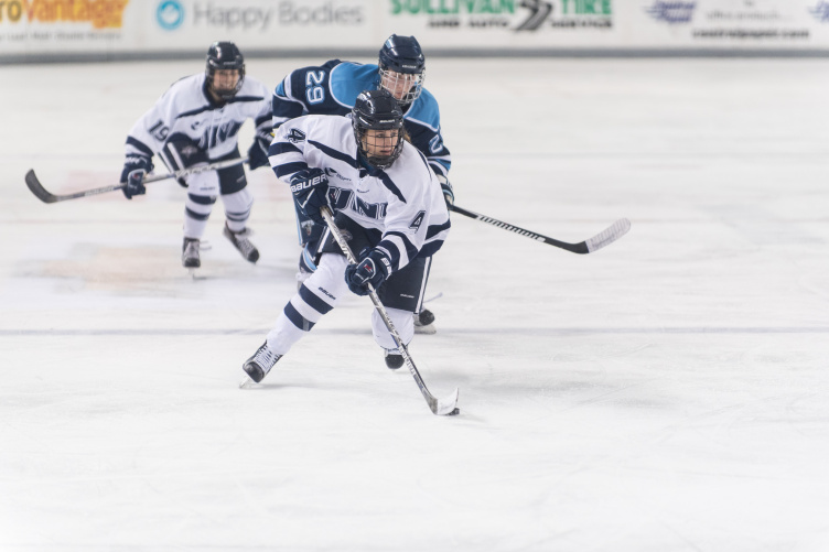 UNH hockey player on the ice during a game at the Whittemore Center Arena