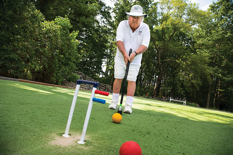 UNH alumnus Bert Myer ’67 playing croquet