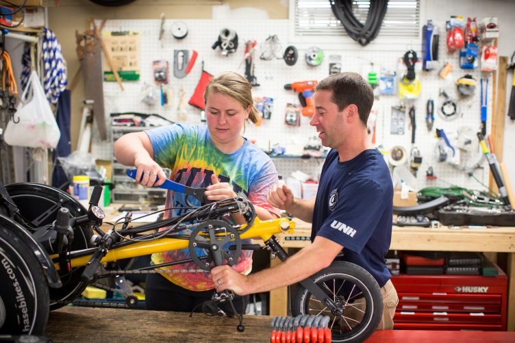 Northeast Passage staff working on an adaptive bicycle