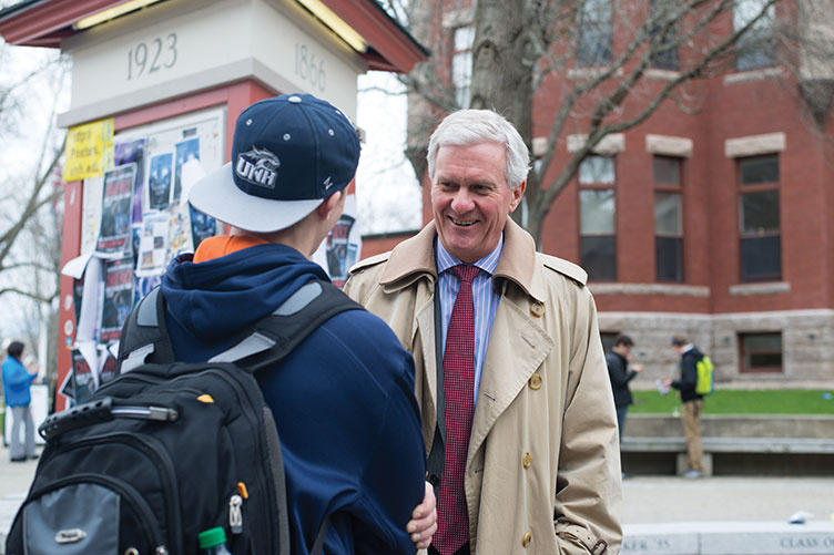 UNH president Mark W. Huddleston talking to a student