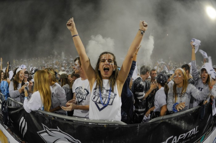 Hailey Simpson ’18 cheering in the student section at a UNH football game