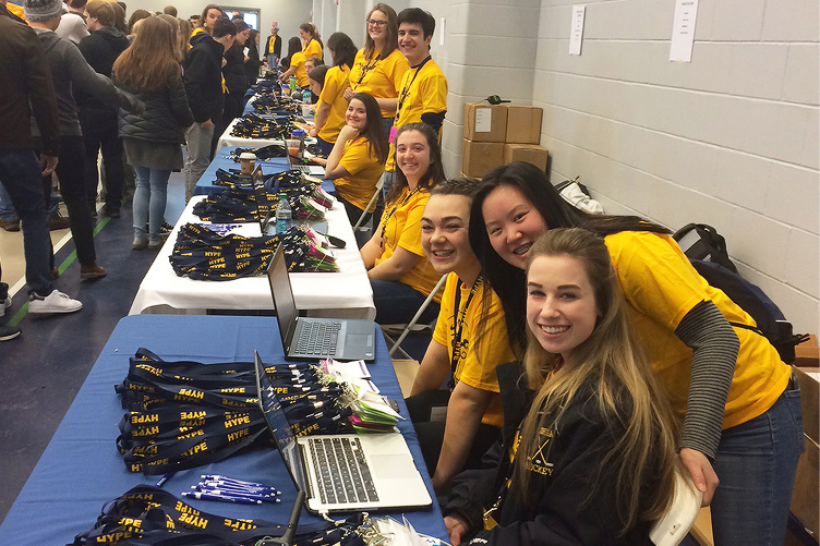 students manning registration table at HYPE