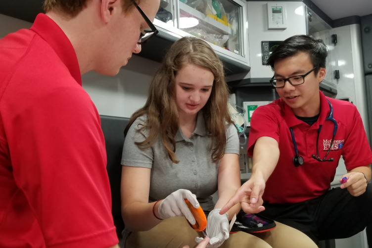 UNH's Adam Huynh working with others as an EMT