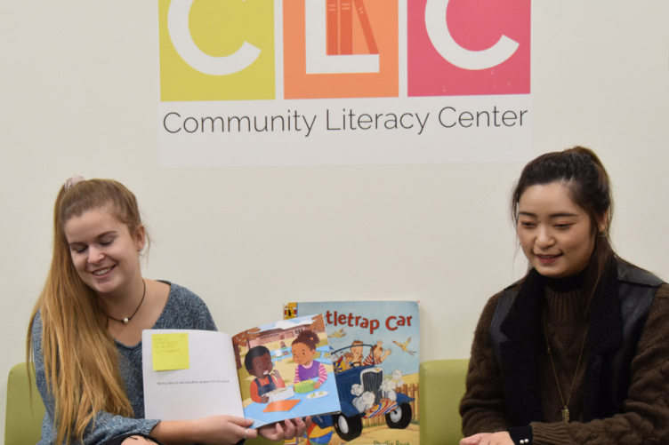 UNH student reading to small children 