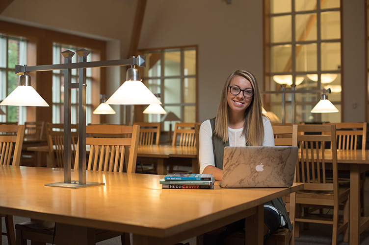 UNH student Charlotte Harris in the library on the Durham campus