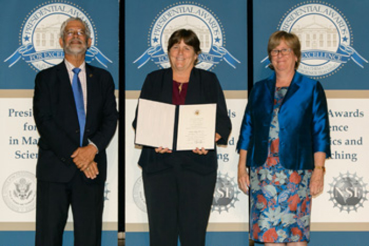 UNH Alumna receiving an award