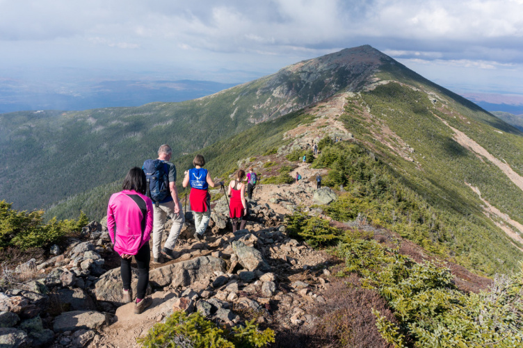 People hiking along mountain ridge