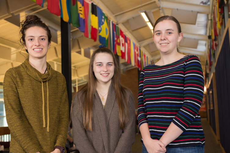 UNH students with international flags 