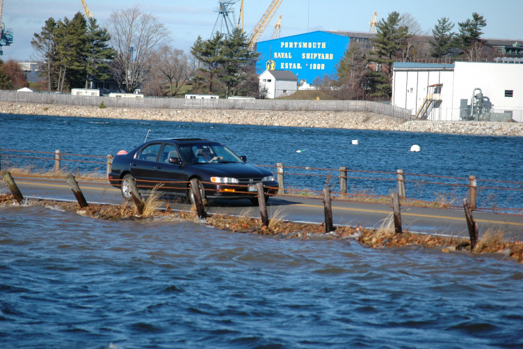 Car driving on flooded roadway